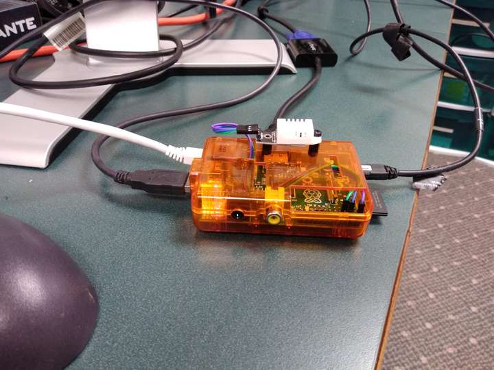 A Raspberry Pi computer in case with a temperature sensor mounted on top