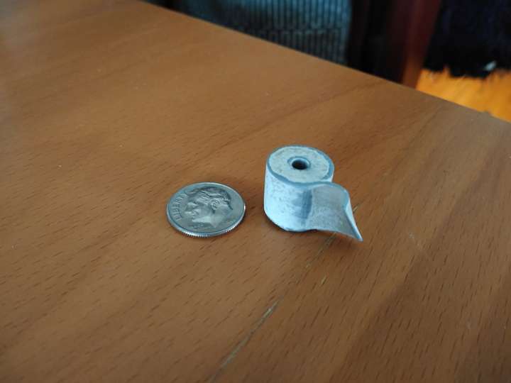 A plastic toilet paper roll about the size of a dime
